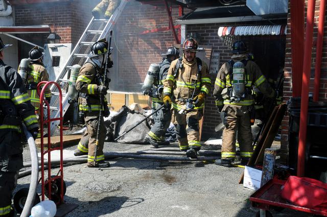 Firefighter Mike Nelson coming out of the building fire on South Third Street.